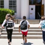 School children running into school
