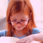 Child over a book